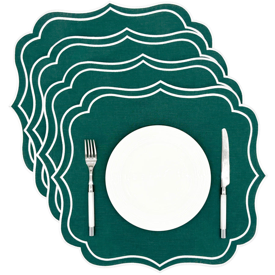 Four green Charlotte scalloped placemats with white embroidered edge, stacked, included in the set
