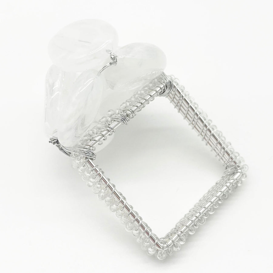 Close-up of the white beaded Pebble Stone napkin ring included in the set