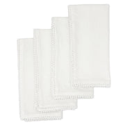 Flat lay of four white Baby's Breath cotton napkins with hand-knotted trim included in the set