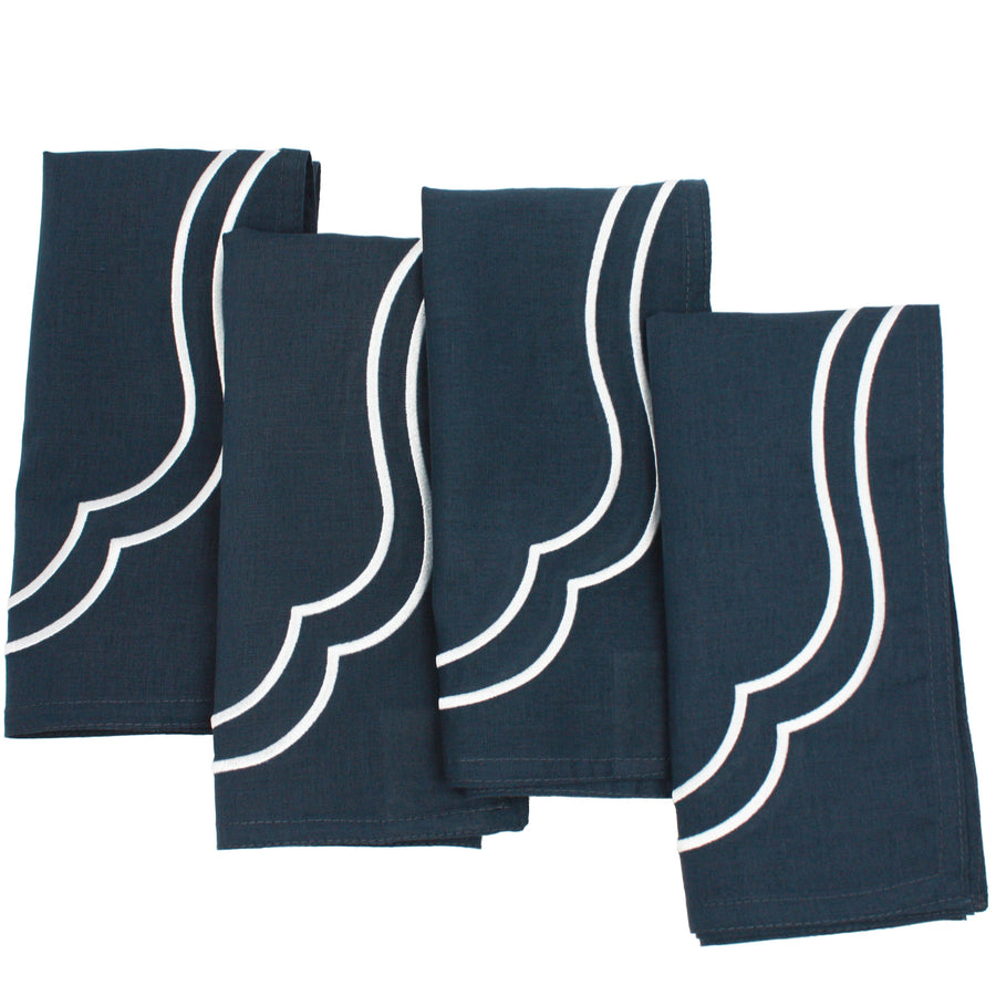 Flat lay of navy Charlotte cotton linen napkins with white scallop embroidery included in the set