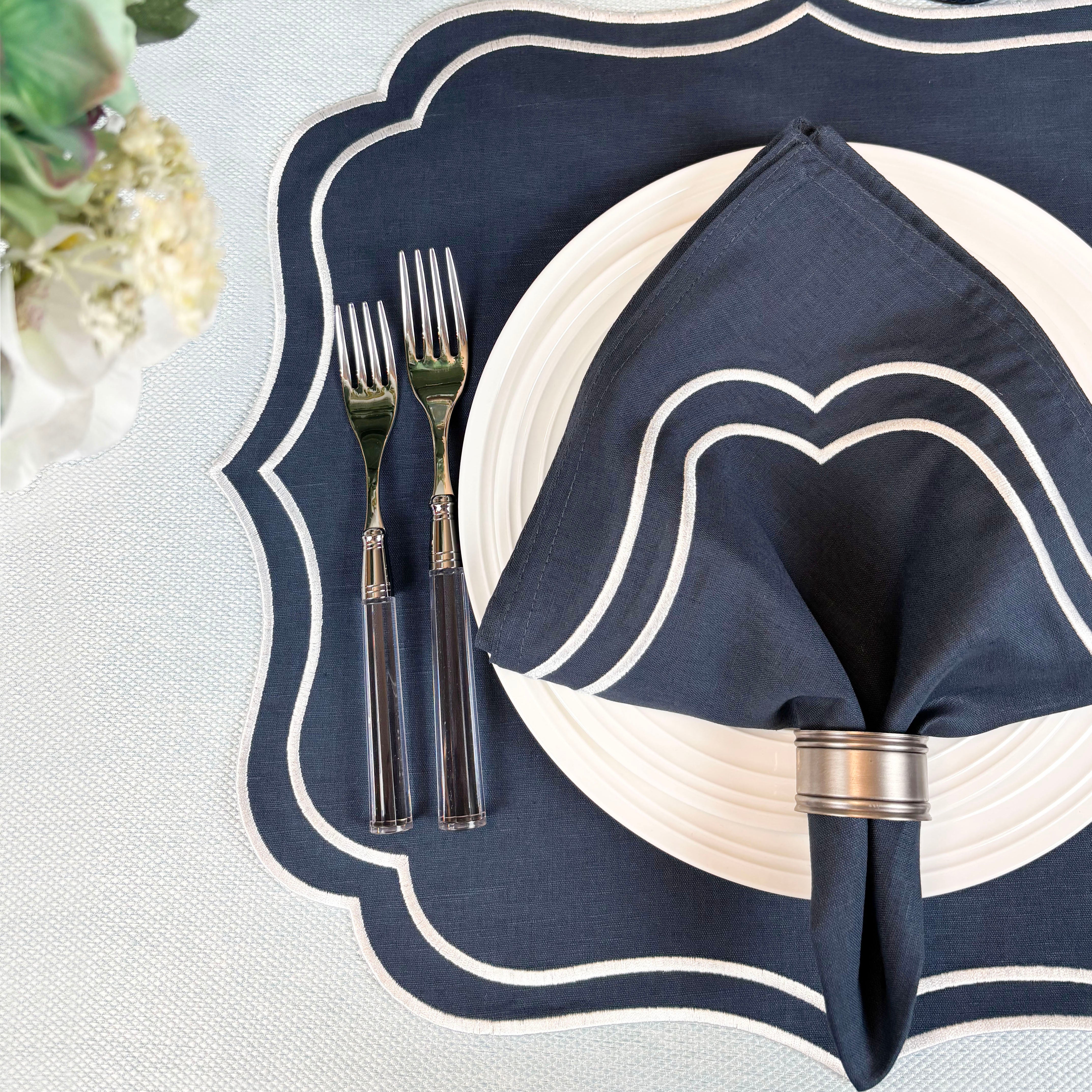 Navy Charlotte embroidered napkin on a navy scalloped Charlotte placemat