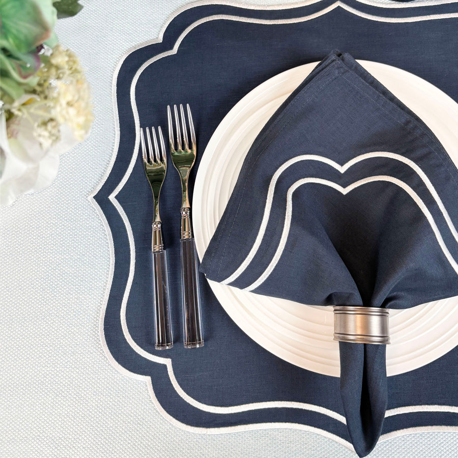 Navy Charlotte embroidered napkin on a navy scalloped Charlotte placemat