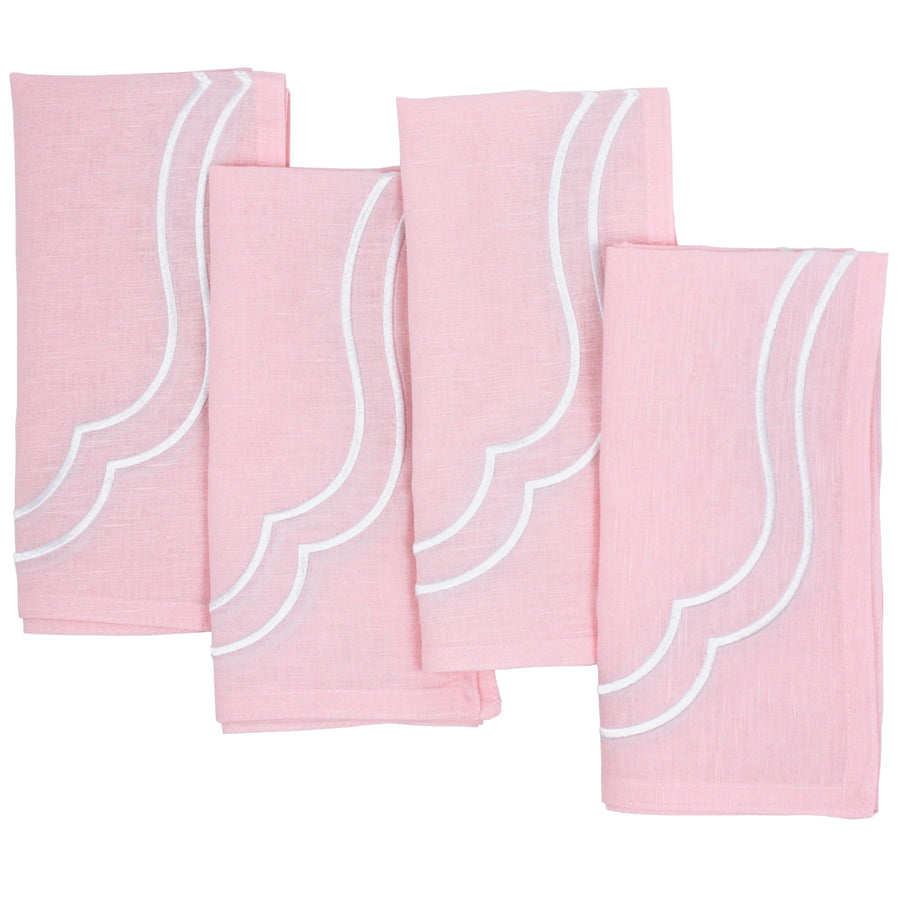 Four light pink Charlotte cotton linen napkins with white scallop embroidery, laid flat